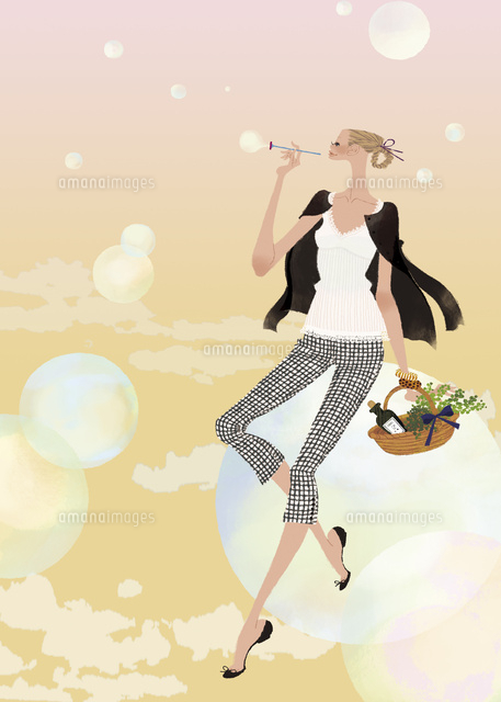 大きなシャボン玉に座ってシャボン玉を吹く女性
(c)Yuko Yoshioka