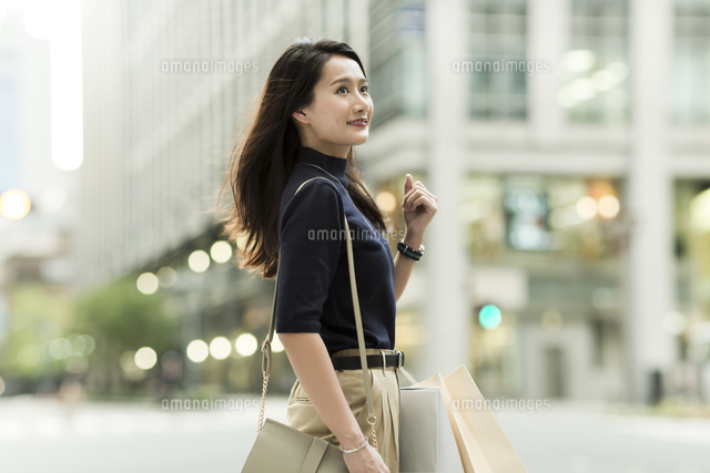 ショッピングバッグを持つ若い女性
(c)RYO
