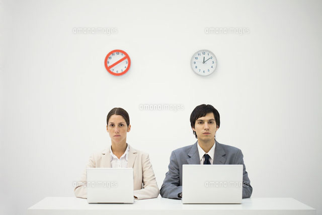 Office workers sitting below clocks, using laptops
(c)Ale Ventura/PhotoAlto