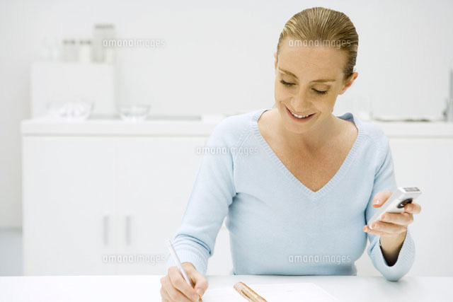 Woman writing in notebook and holding cell phone
(c)Sigrid Olsson/PhotoAlto
