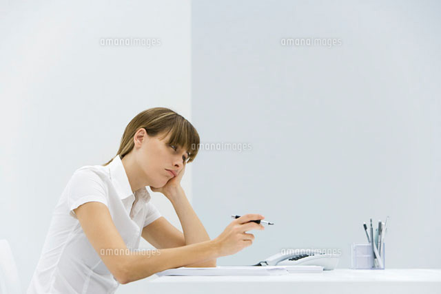 Woman sitting at desk, resting head in her hand
(c)Alix Minde/PhotoAlto