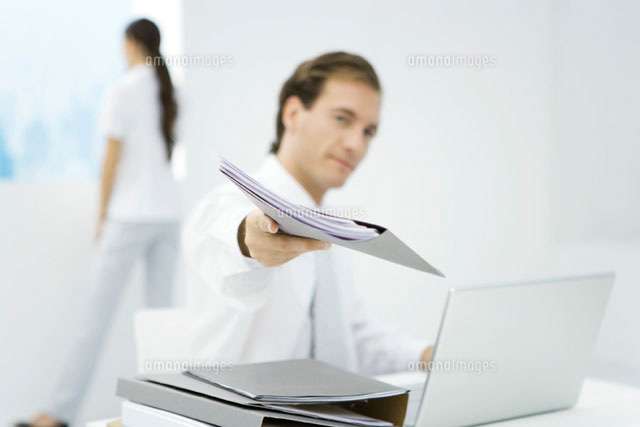Professional man handing folder to camera
(c)Alix Minde/PhotoAlto