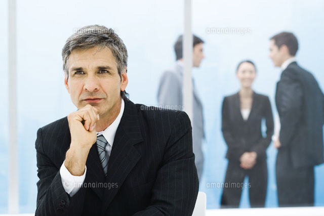 Graying businessman with hand under chin,looking away
(c)Frederic Cirou/PhotoAlto