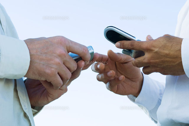 Two men face to face,holding cell phones
(c)Michele Constantini/PhotoAlto