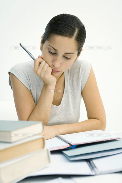 Young woman sitting with stack of books,studying notebook
(c)Sigrid Olsson/PhotoAlto