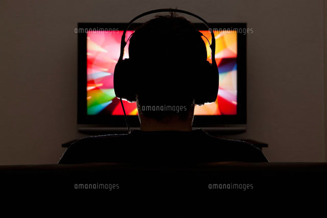 A man wearing headphones and watching television
(c)Twins/fStop
