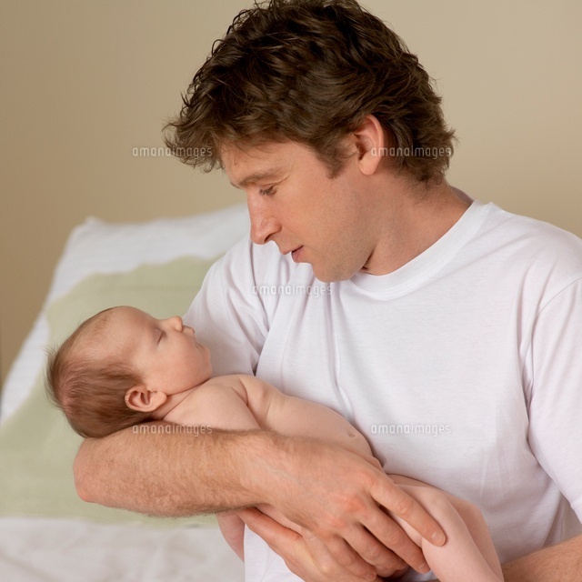 Sleeping Baby Held by Father
(c)Radius Images