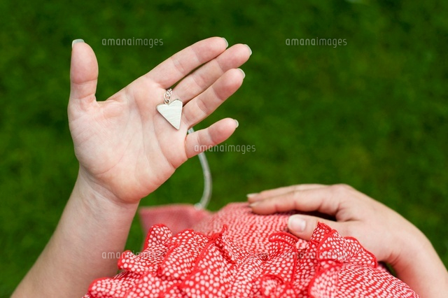 Pregnant Woman holding Heart Pendant, Salzburg, Austria
(c)Radius Images