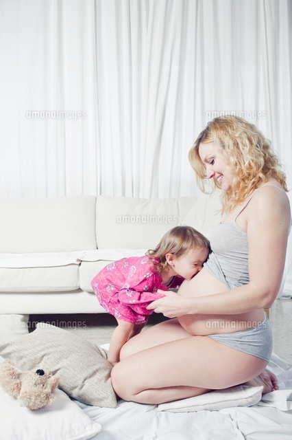 Daughter Kissing Pregnant Woman's Stomach
(c)Radius Images