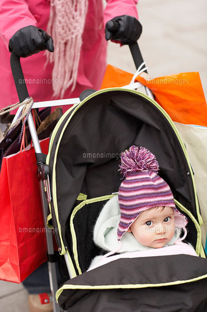 Mother walking with baby in stroller close up on baby
(c)moodboard