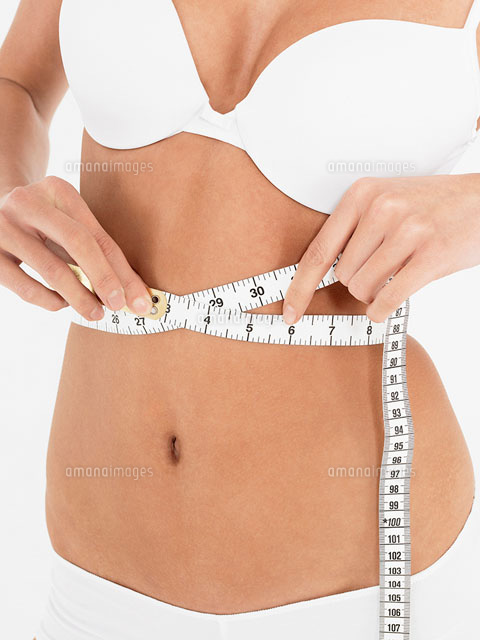 Young Woman in underwear Measuring own Waist front view
(c)moodboard