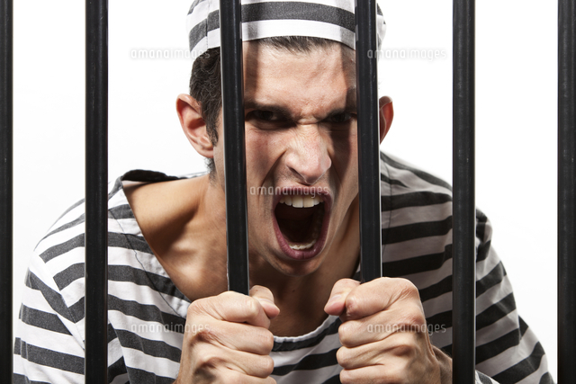 Convict yells through prison bars
(c)moodboard