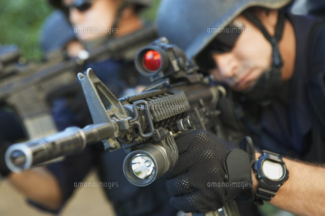 Swat officer aiming guns
(c)moodboard