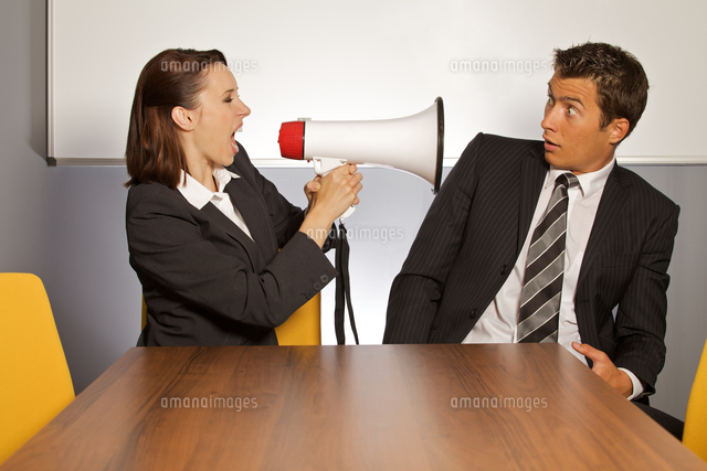 Businesswoman shouting at businessman through megaphone
(c)moodboard