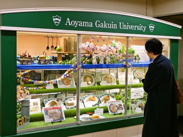 「懐かしい！」と学食で写真を撮る井本さん