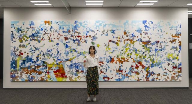 制作した壁画の前に立つ中村琴梨さん