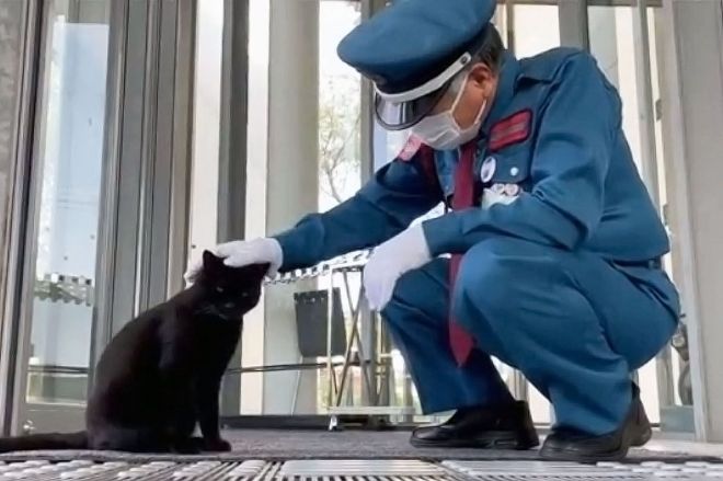 警備員の馬屋原定雄さんと黒猫のケンちゃん