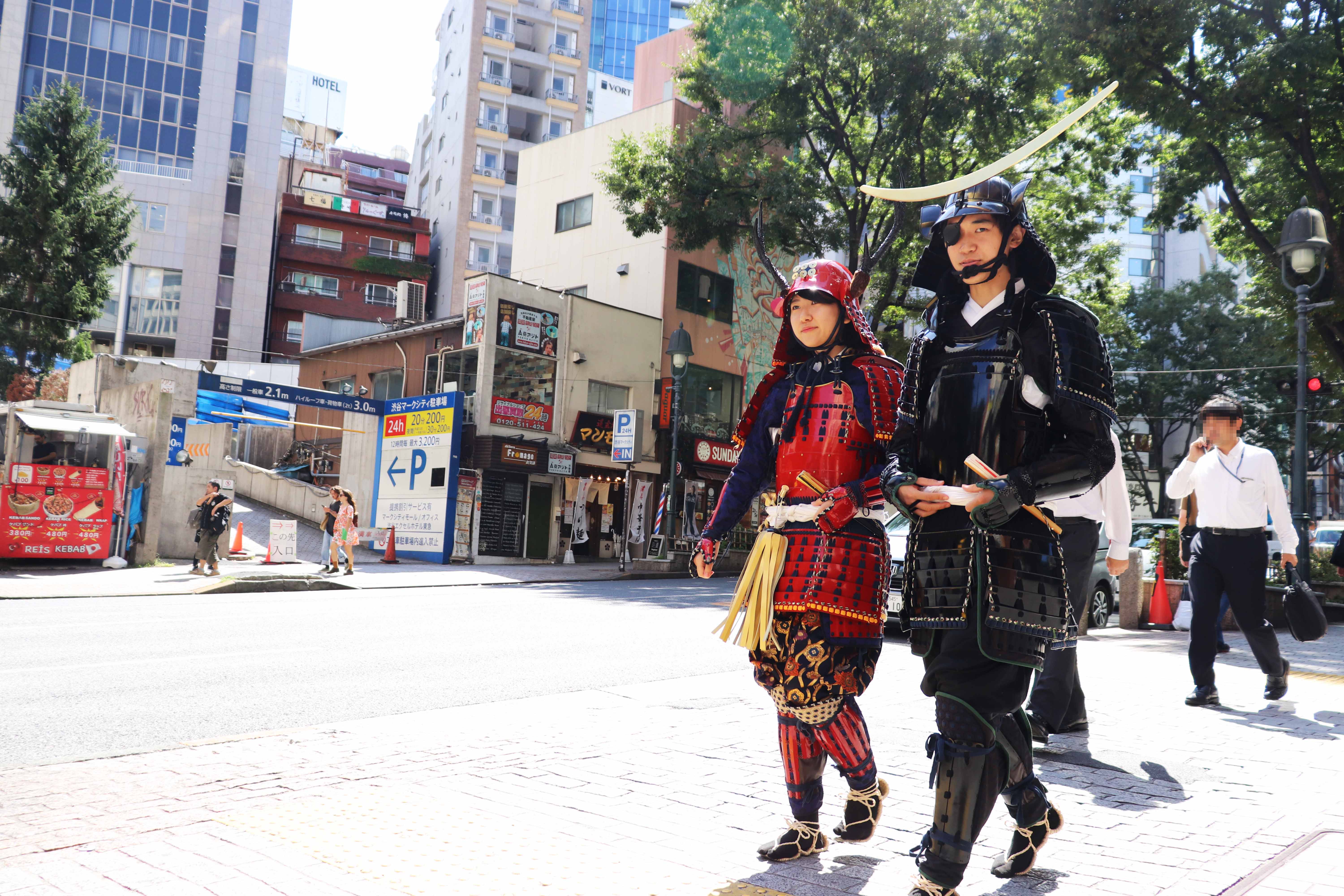 posing for photos in samurai armor at Dogenzaka