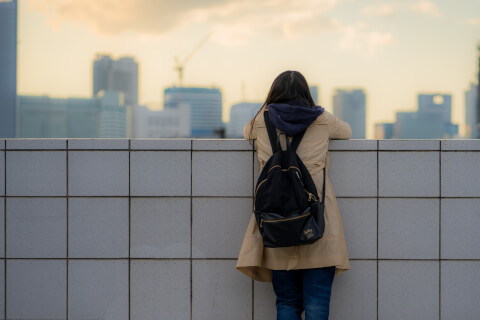 橋から空を見る女性