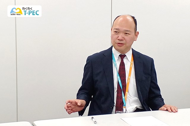 職場改善の現状を説明する佐久間さん