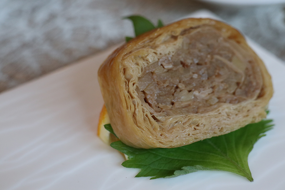 茶燻金縷香素鵝 源自清朝的宮廷料理,利用豆腐皮層層堆疊,裡頭包了金針菇跟筍絲,再壓實、蒸製、煙燻,以模仿真鵝口感。(示意圖)