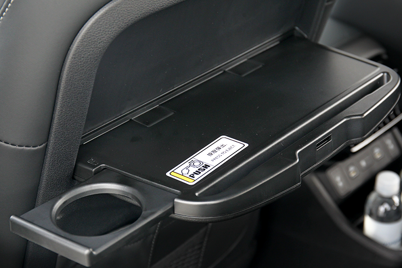 前座椅背附有折疊餐桌,而餐桌還有杯架與放置平板凹槽設計。